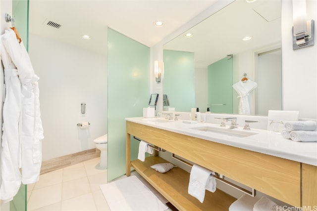 bathroom with vanity, toilet, and tile patterned flooring