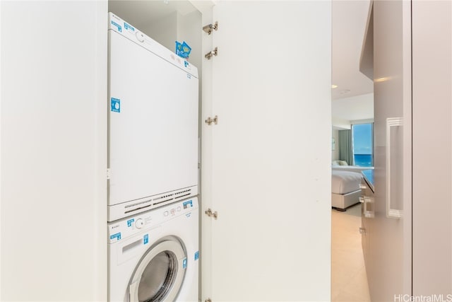 laundry area with stacked washing maching and dryer