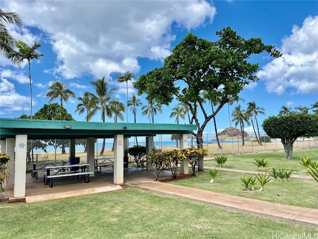 view of property's community featuring a yard and a water view