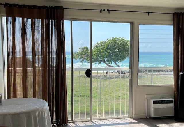 doorway to outside with a view of the beach and a water view