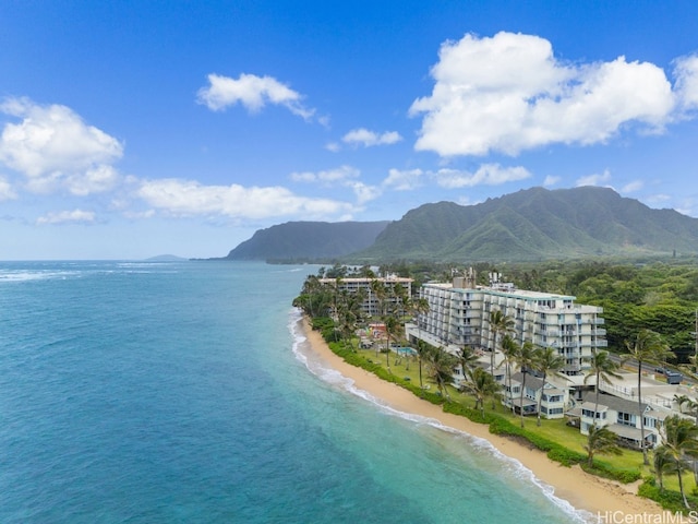 drone / aerial view featuring a view of the beach and a water and mountain view