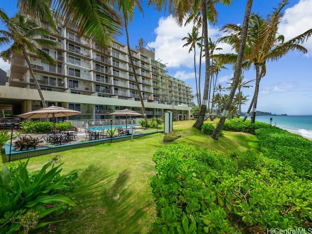 surrounding community featuring a lawn and a water view