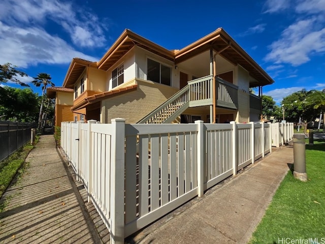 exterior space with a fenced front yard and brick siding