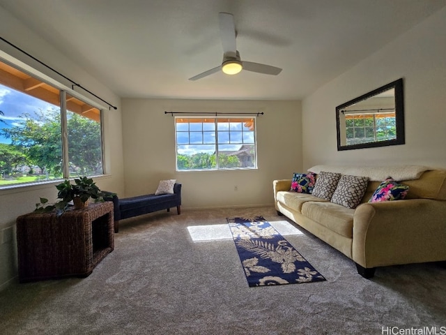 carpeted living room with ceiling fan