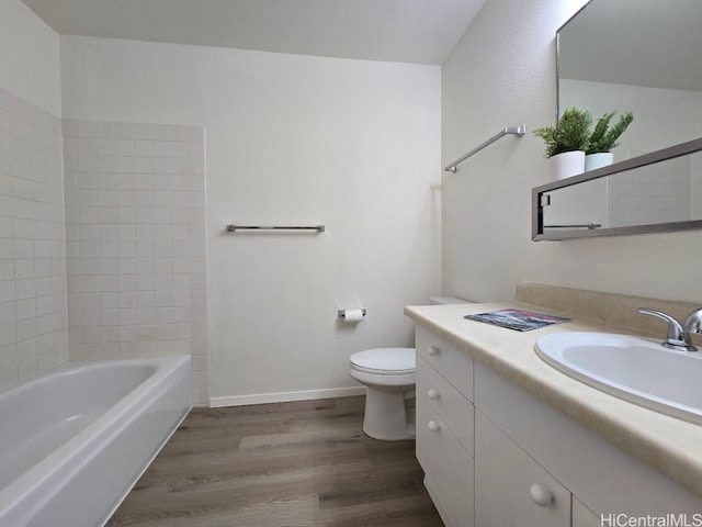 bathroom with vanity, hardwood / wood-style flooring, and toilet