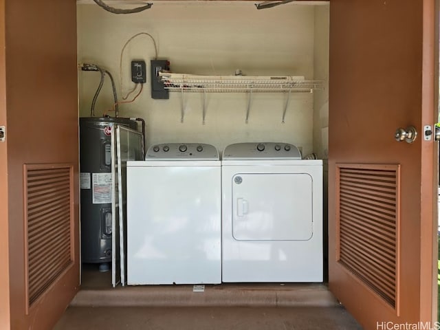 washroom with washing machine and dryer and electric water heater