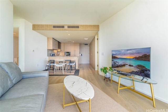 living room with light hardwood / wood-style flooring