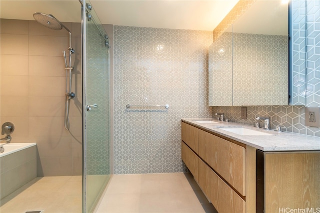 bathroom featuring tile walls, vanity, plus walk in shower, and backsplash