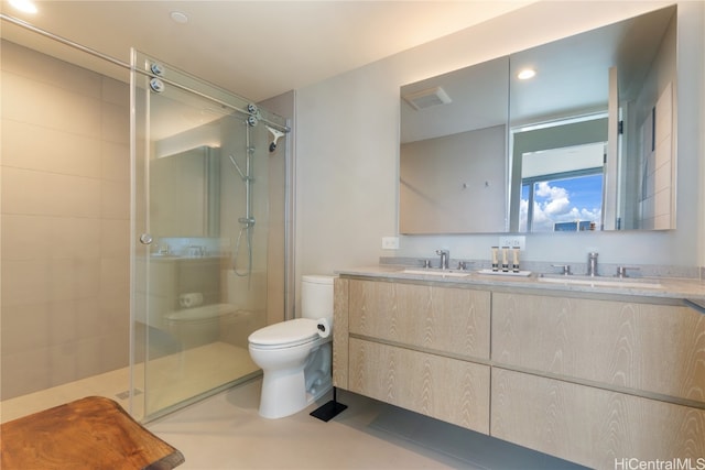 bathroom with vanity, toilet, and a shower with shower door