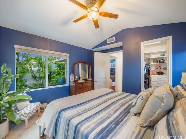 bedroom with lofted ceiling, a spacious closet, carpet floors, a closet, and ceiling fan