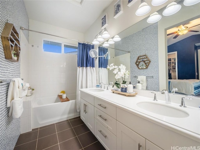 bathroom with shower / tub combo, vanity, tile patterned flooring, and ceiling fan