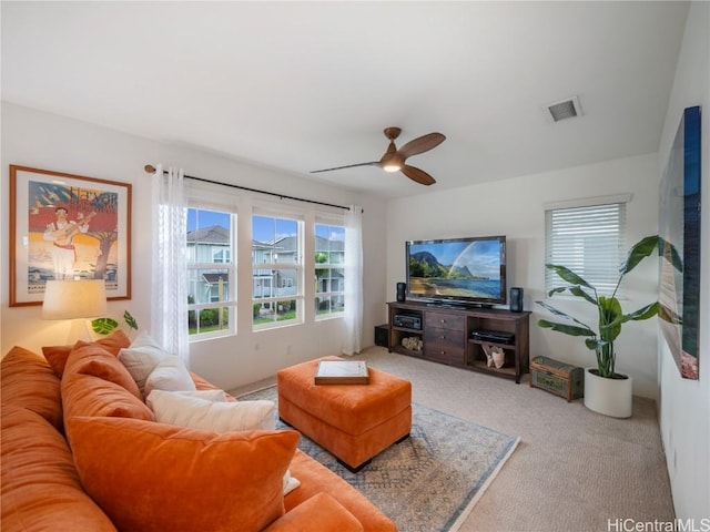 carpeted living room with ceiling fan