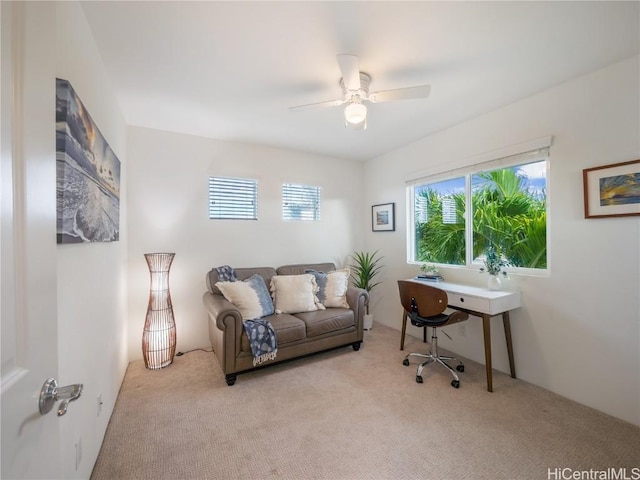 home office featuring ceiling fan and light carpet