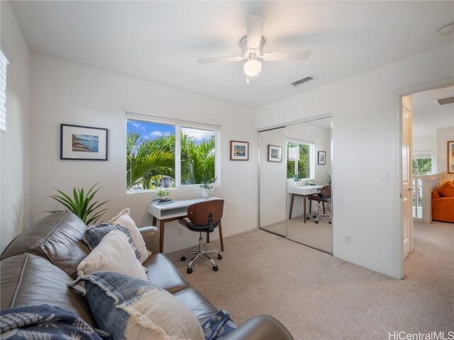 carpeted office featuring ceiling fan