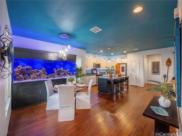 dining room with dark hardwood / wood-style flooring