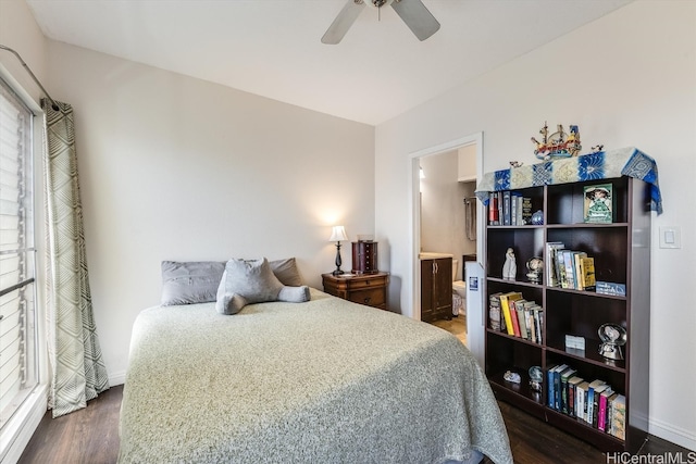 bedroom with ceiling fan, dark hardwood / wood-style flooring, multiple windows, and ensuite bath