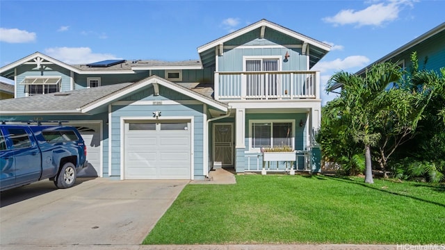 view of front facade with a balcony, a front lawn, and a garage