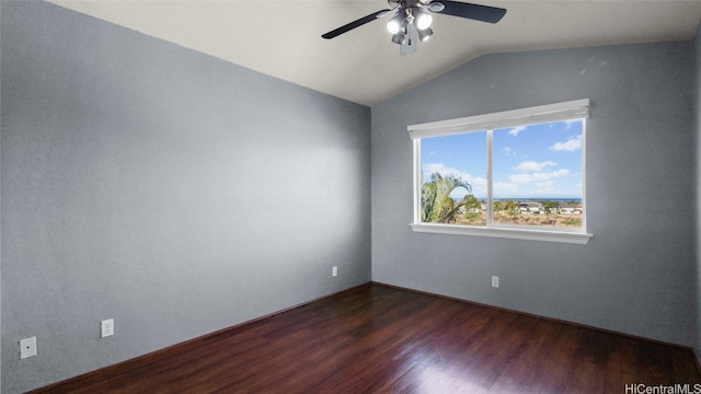 empty room featuring ceiling fan, dark wood-type flooring, and vaulted ceiling