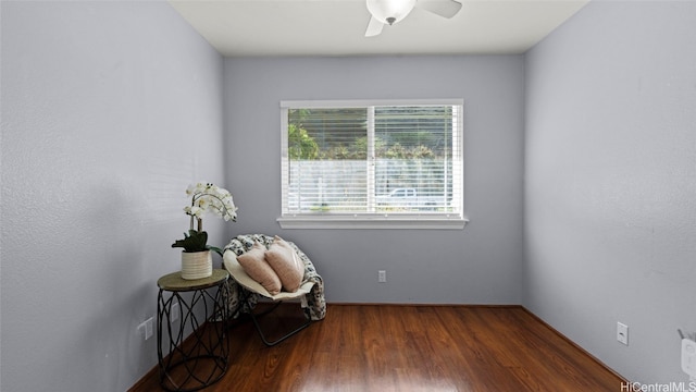 sitting room with ceiling fan and dark hardwood / wood-style floors