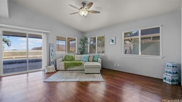 unfurnished living room featuring a wealth of natural light, lofted ceiling, dark hardwood / wood-style floors, and ceiling fan