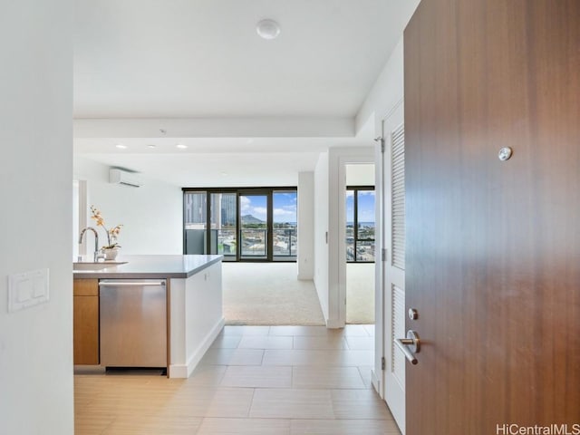 kitchen with dishwasher, light carpet, a wall unit AC, and sink