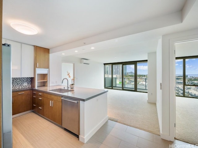 kitchen with dishwasher, white refrigerator, sink, light colored carpet, and kitchen peninsula