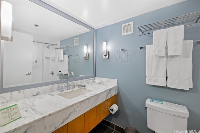 full bathroom with vanity, toilet, tiled shower / bath combo, and tile patterned flooring