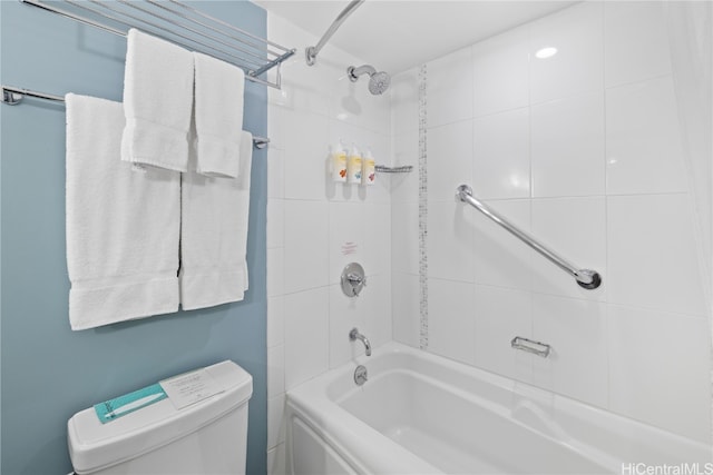 bathroom featuring toilet and tiled shower / bath combo