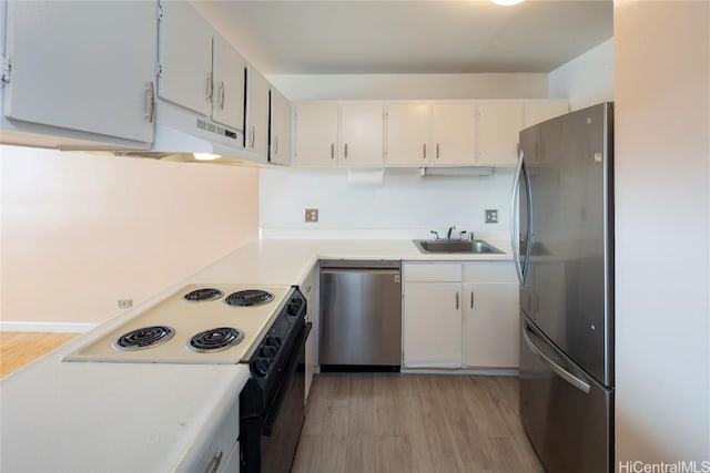 kitchen featuring sink, appliances with stainless steel finishes, white cabinets, and light hardwood / wood-style flooring