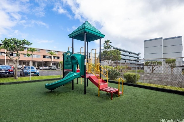 view of playground with a lawn