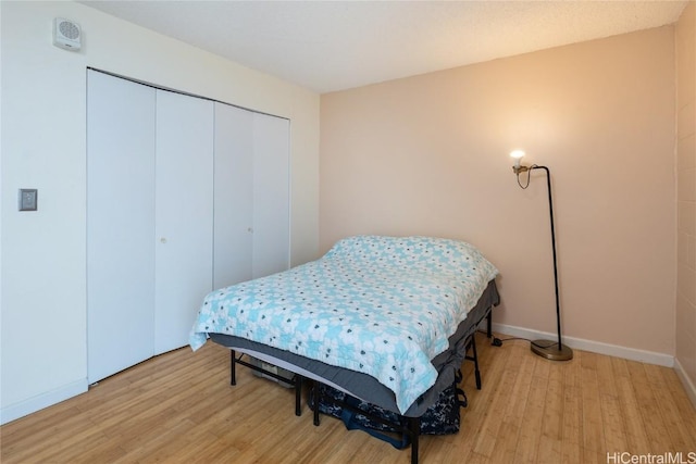 bedroom featuring light wood-type flooring and a closet