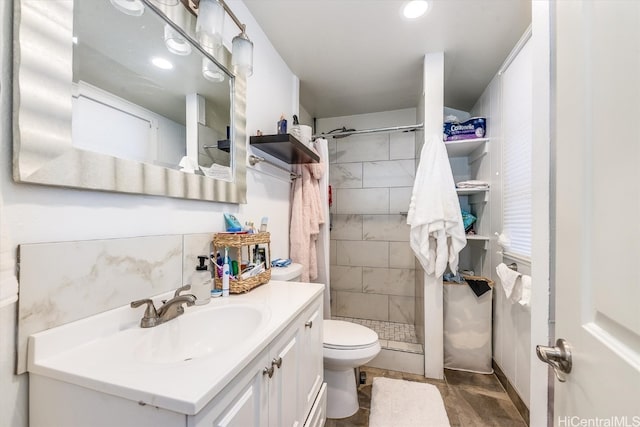 bathroom with vanity, toilet, and walk in shower