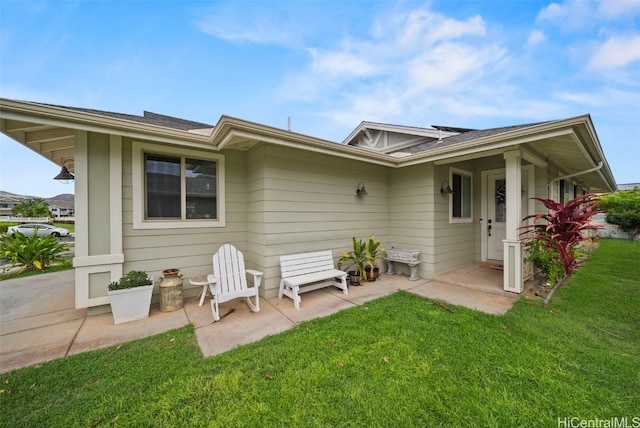 rear view of property featuring a lawn