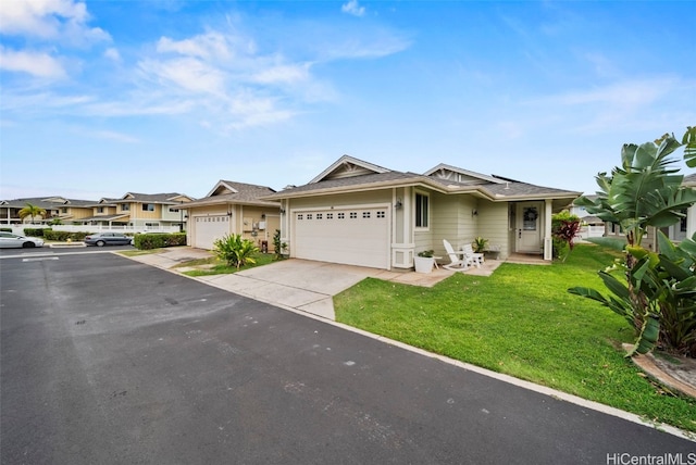 view of front of home with a garage and a front lawn