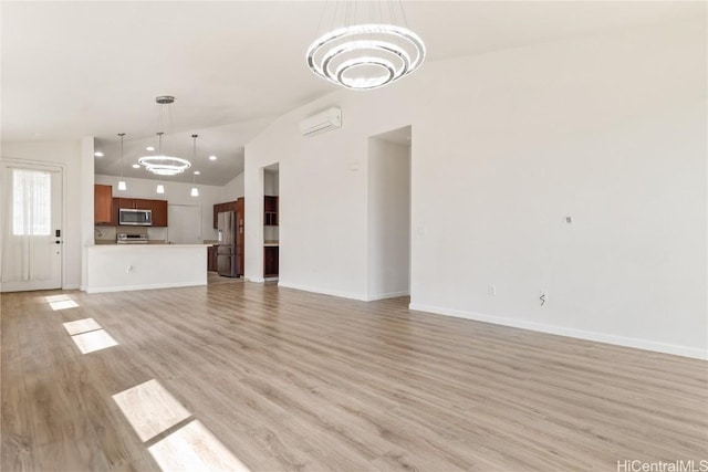 unfurnished living room featuring high vaulted ceiling, an AC wall unit, a chandelier, and light hardwood / wood-style flooring