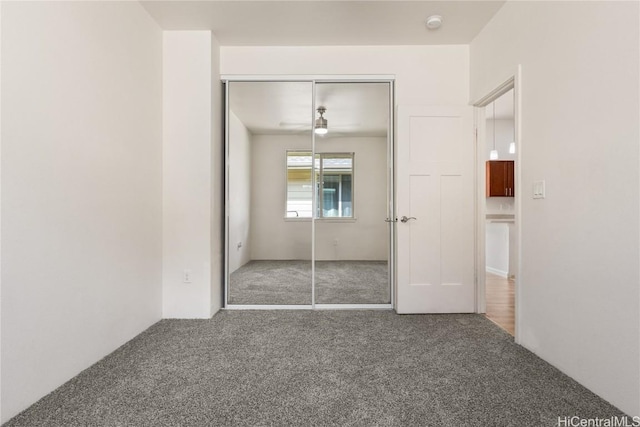 unfurnished bedroom with carpet flooring and a closet