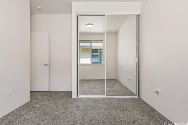 unfurnished bedroom with a closet and carpet