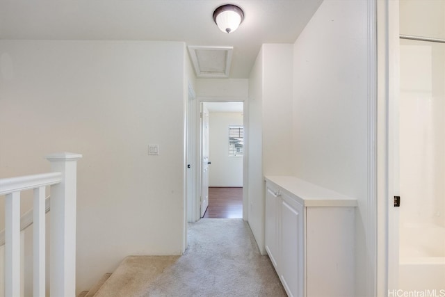 hallway featuring light colored carpet