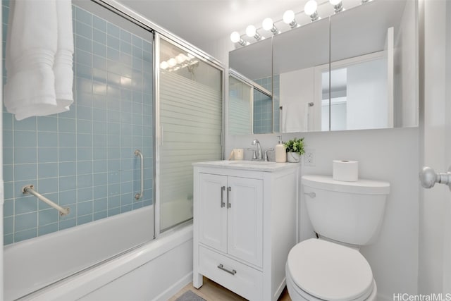 full bathroom with vanity, toilet, and enclosed tub / shower combo