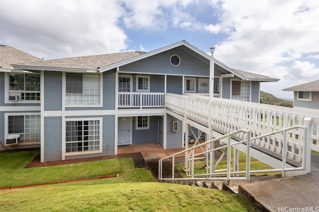 rear view of house featuring a lawn