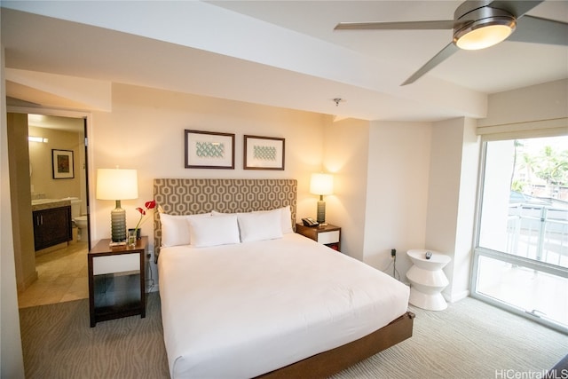 bedroom with ensuite bath, carpet, and ceiling fan