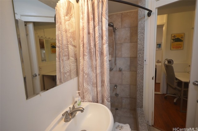 bathroom featuring sink, wood-type flooring, and walk in shower