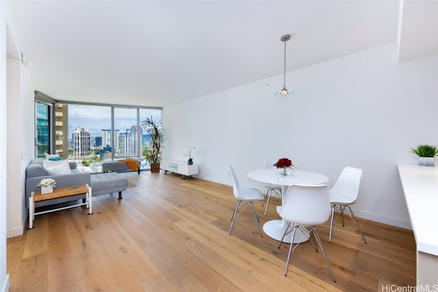 dining room featuring hardwood / wood-style floors and expansive windows