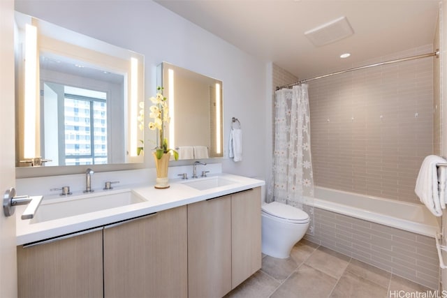 full bathroom with tile patterned flooring, shower / bath combination with curtain, vanity, and toilet