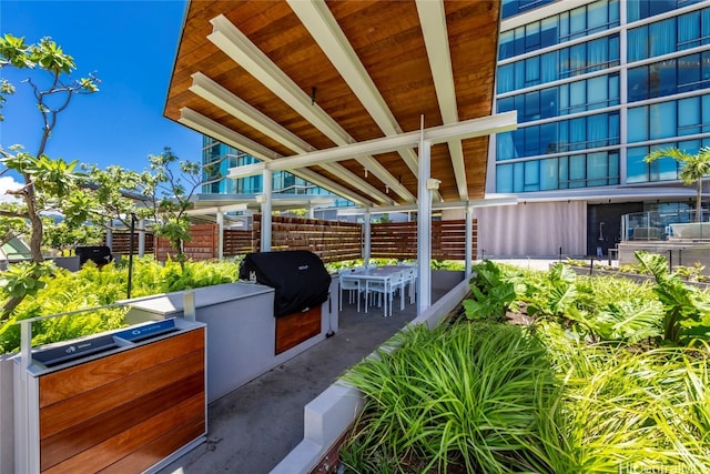 view of patio featuring an outdoor kitchen and a grill