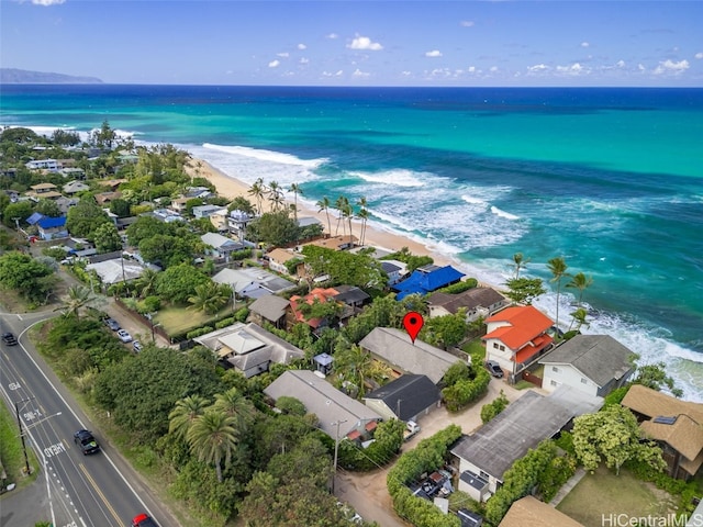 drone / aerial view featuring a water view and a view of the beach