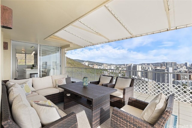 exterior space featuring a balcony, a view of city, and an outdoor living space