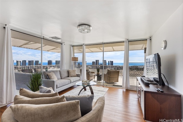 sunroom / solarium featuring an inviting chandelier and plenty of natural light