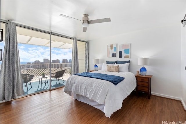 bedroom featuring ceiling fan, access to exterior, dark hardwood / wood-style floors, and expansive windows