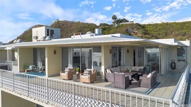 rear view of property with an outdoor living space